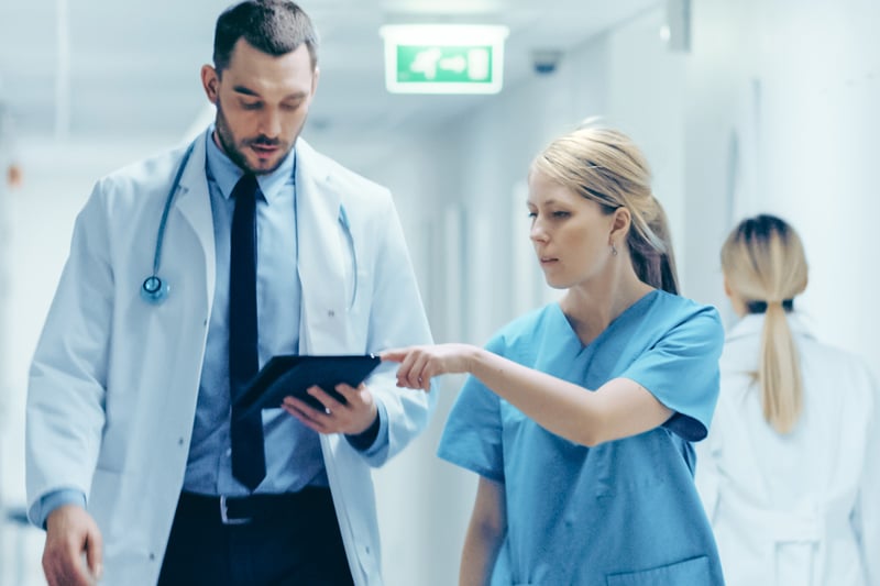 Doctors checking information on digital tablet