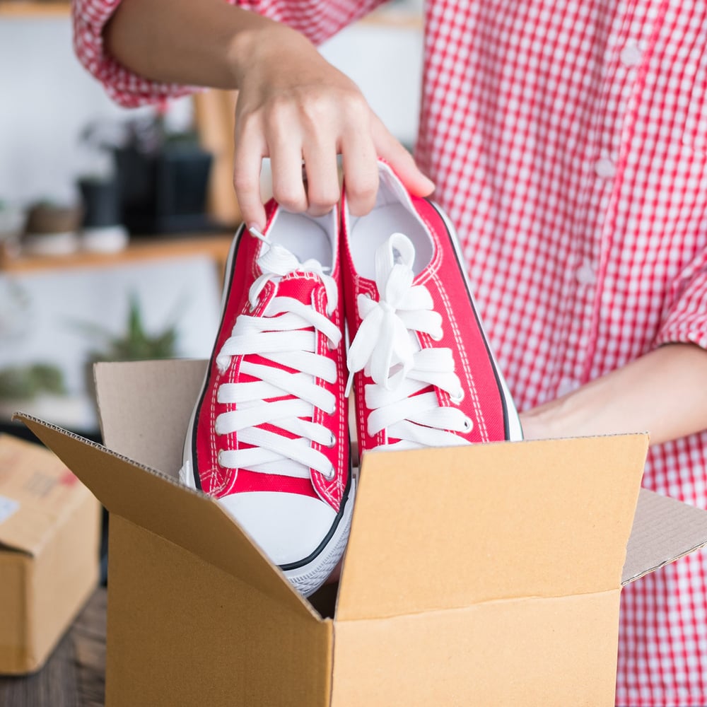 customer putting shoes in box