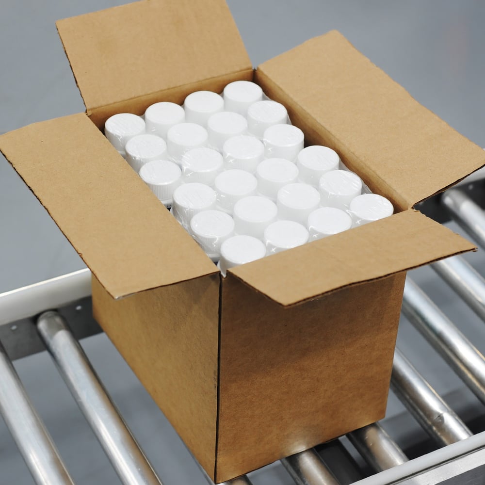 Box with bottles on conveyor belt