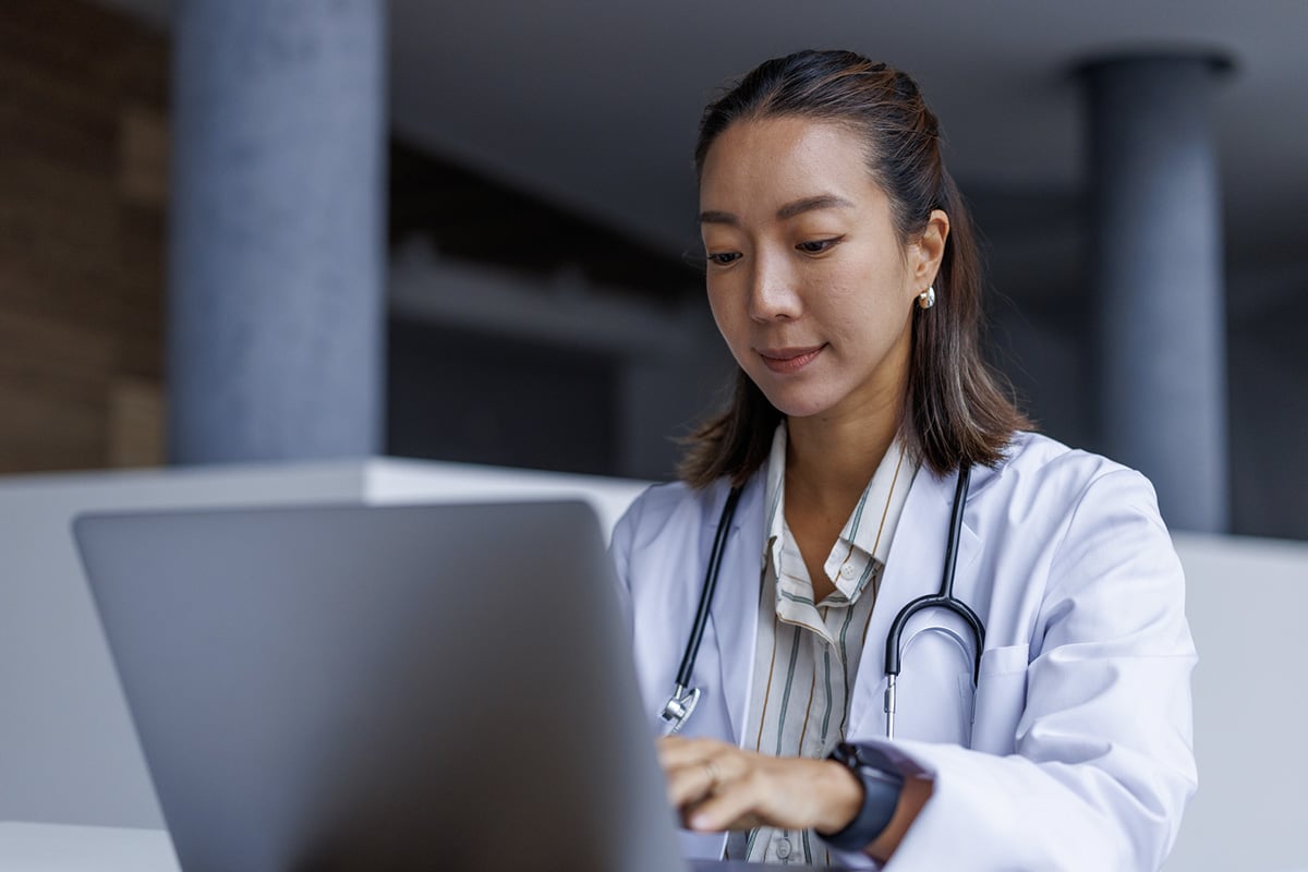 Doctor using TecsysIQ on laptop