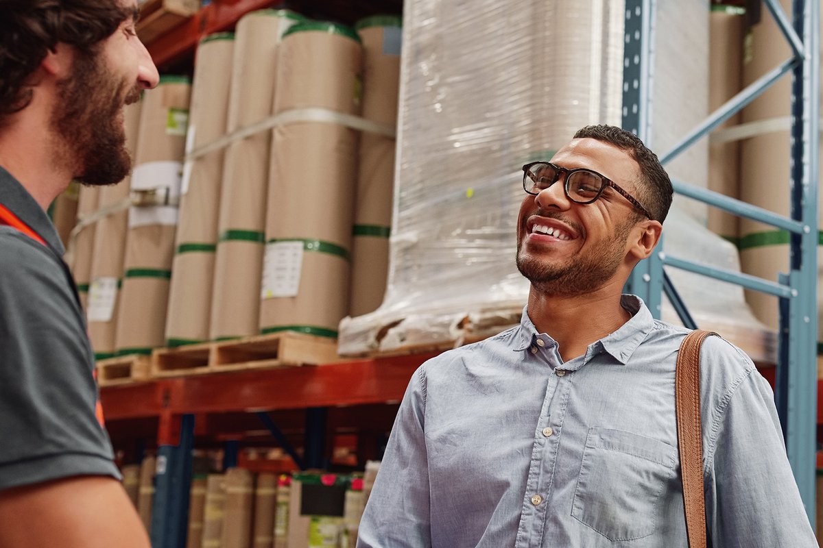 Business professional meeting a warehouse manager