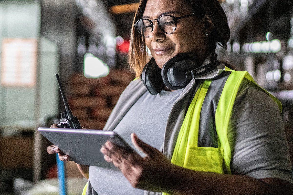 Warehouse manager checking data on digital tablet
