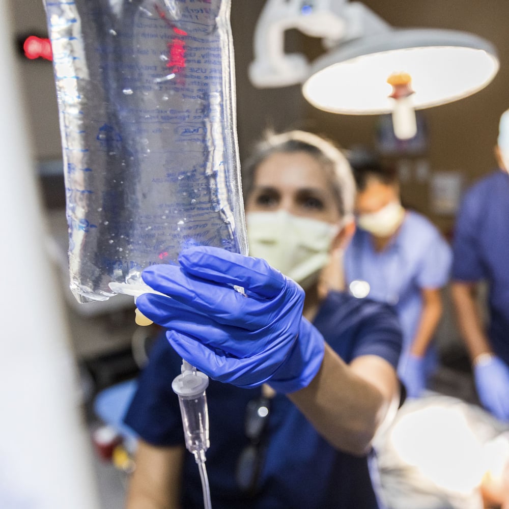 doctor checking IV bag