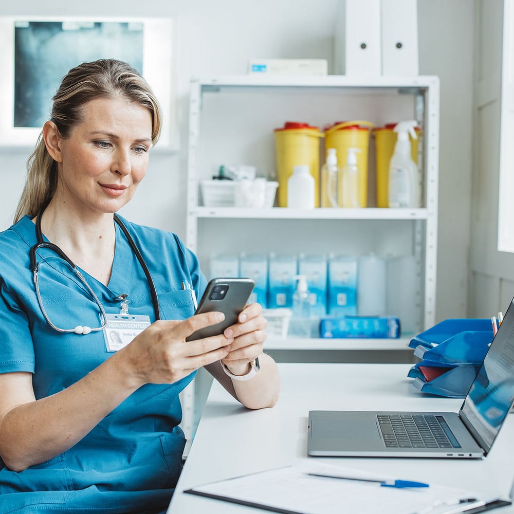 doctor using computer and smartphone 1200
