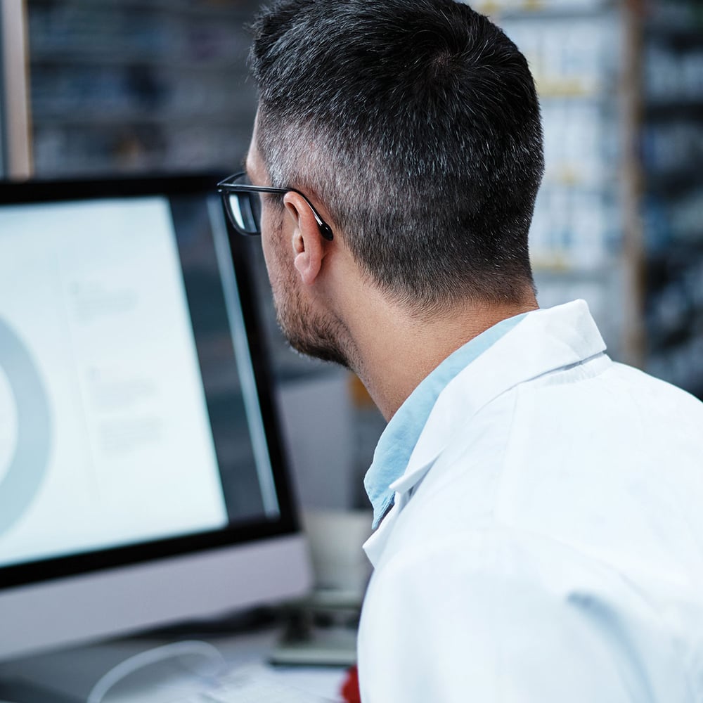 medical professional checking computer screen 1200x1200