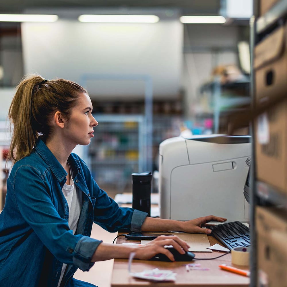 warehouse manager working at their desk in warehouse