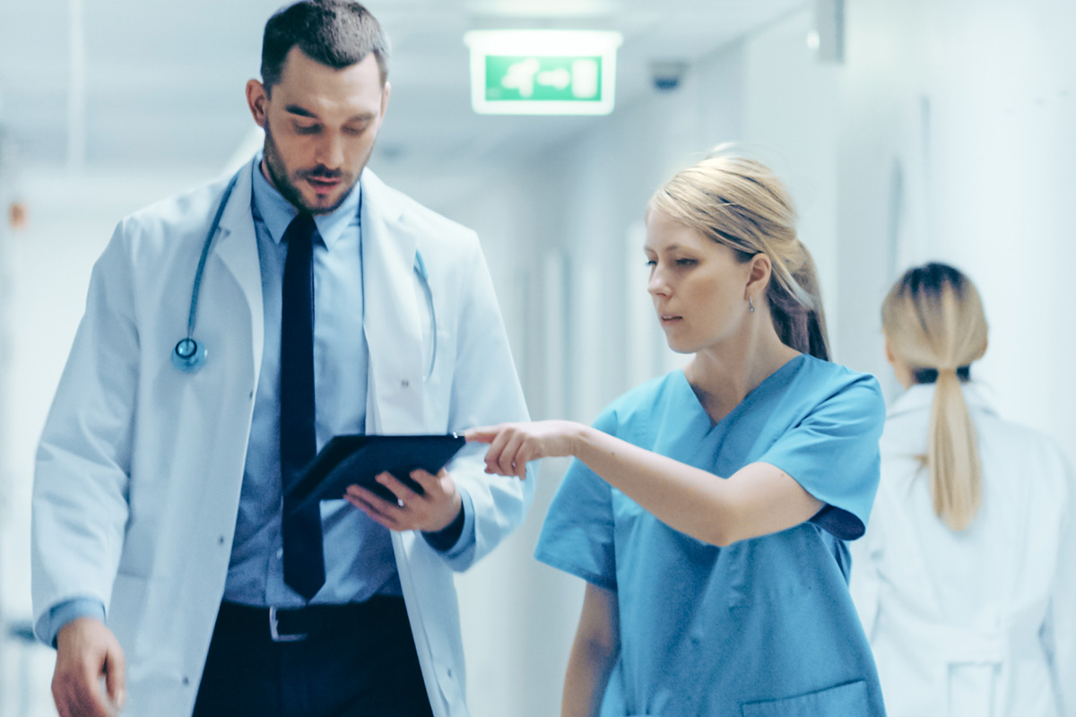 Doctors checking information on digital tablet